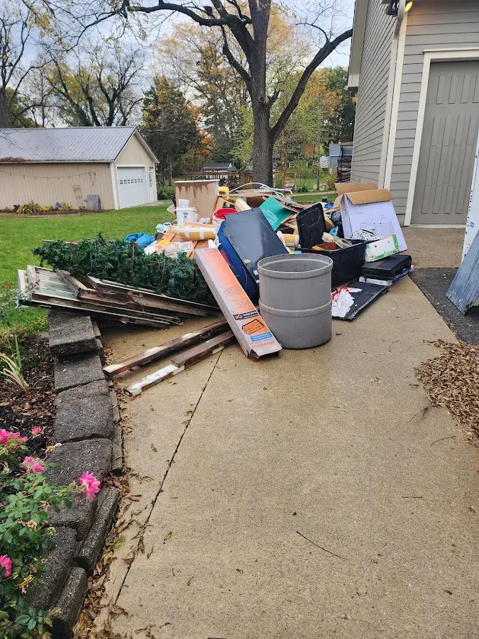 Dumpster being loaded with debris for 30 Yard Dumpster Rental in Lake City